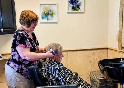 Spring Creek Chalet salon staff giving a haircut.